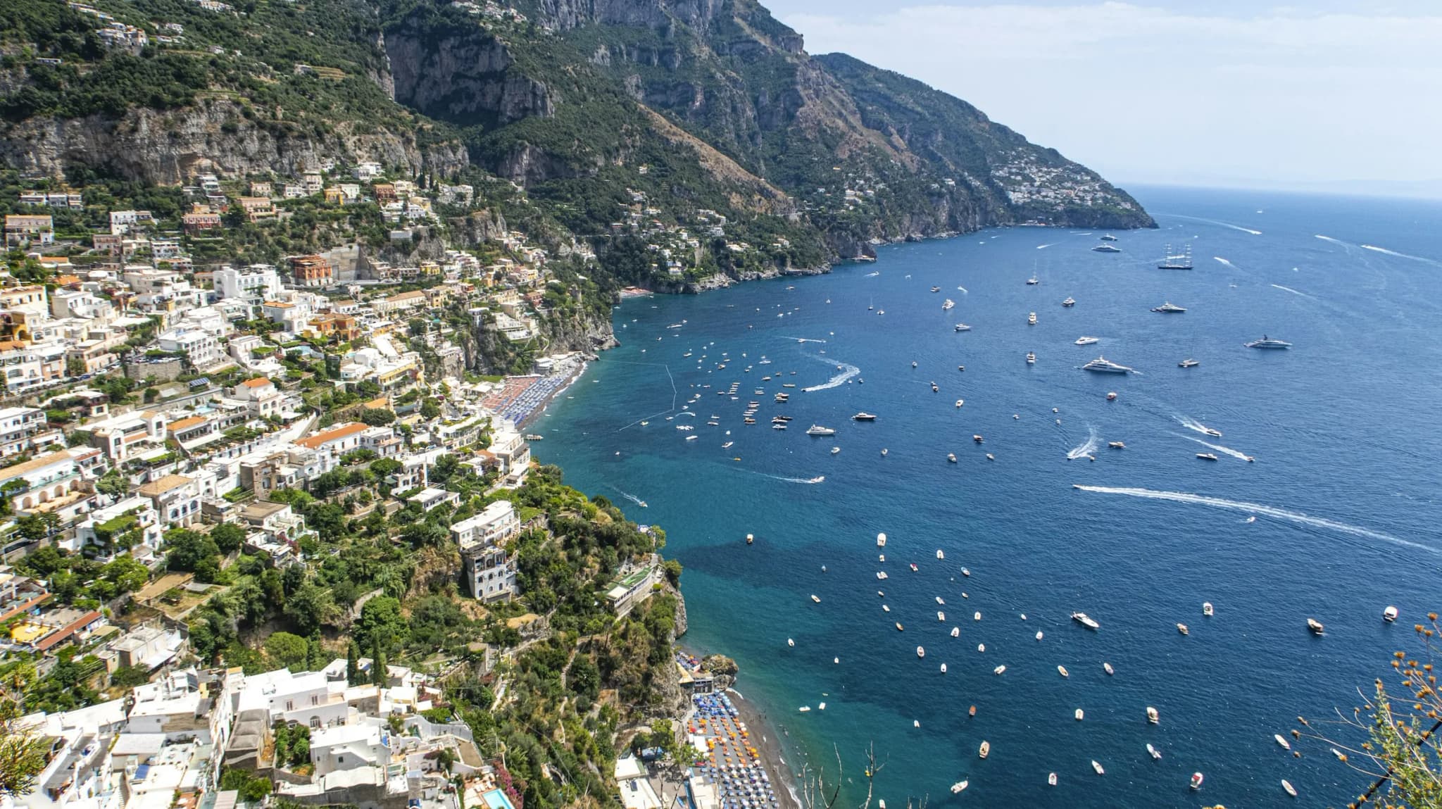 The bay of Positano from above, full of boats at midday