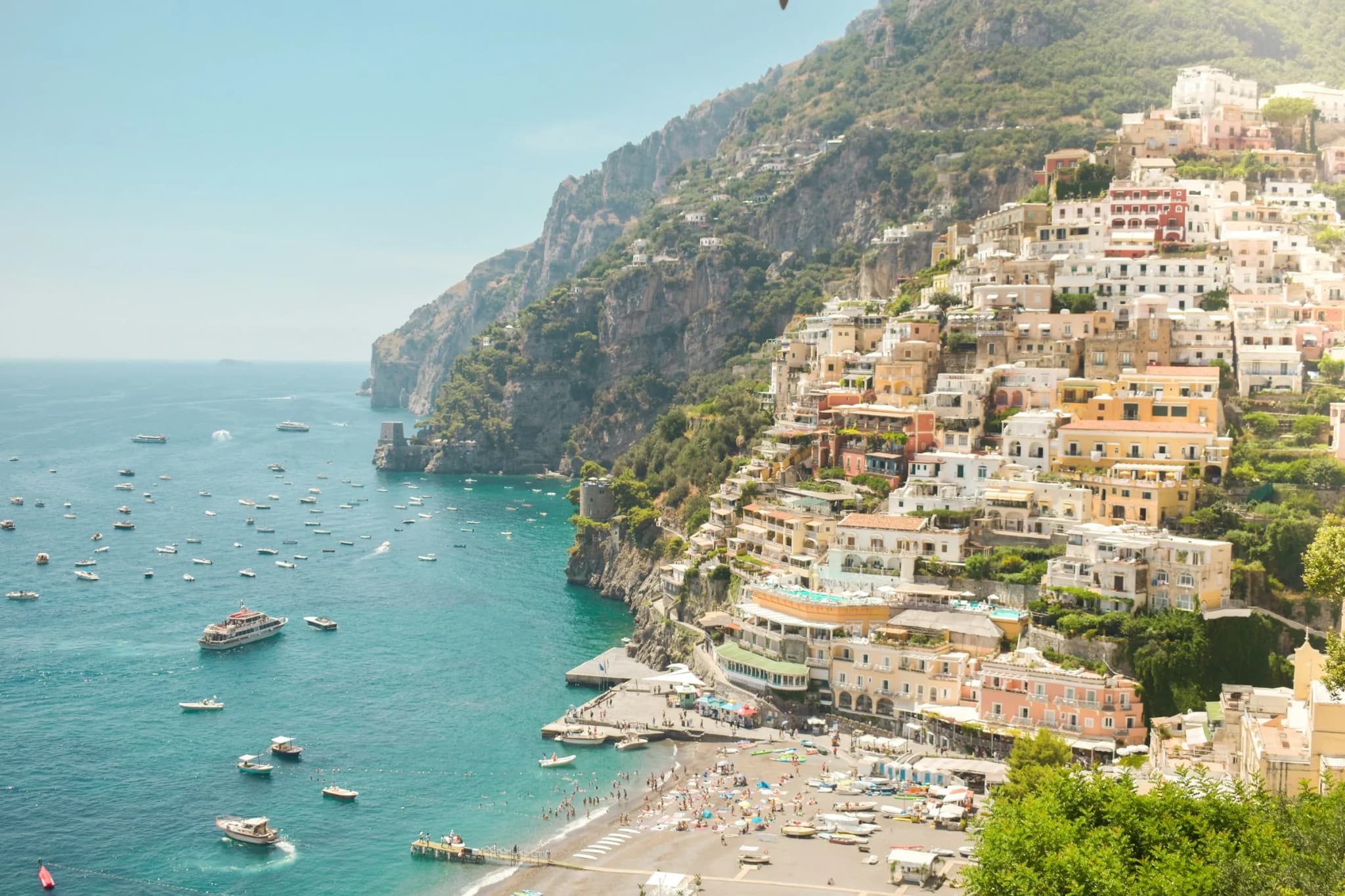 Positano from the road, its houses stepping down to Spiaggia Grande and the boats at anchor