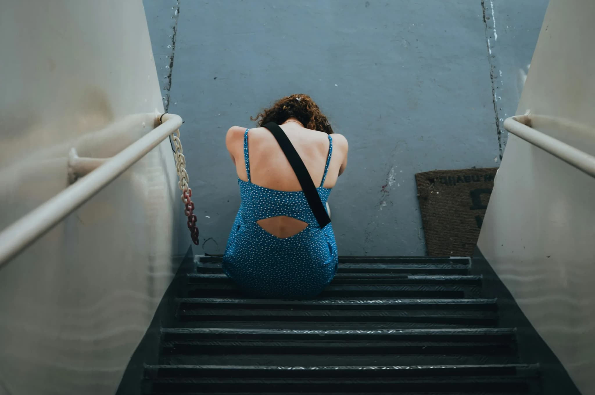A passenger sitting on the ferry stairs